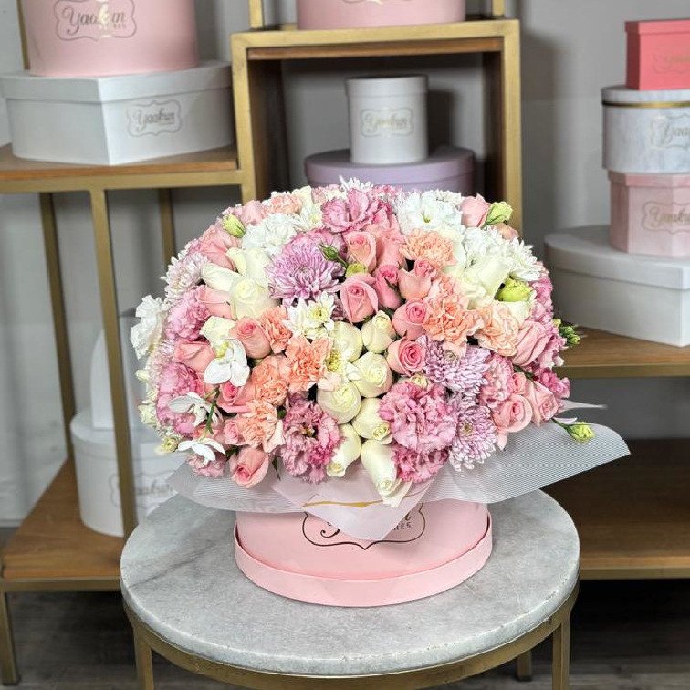 Caja circular rosita con 100 rosas, lisianthus, clavel, roxanas y orquídeas